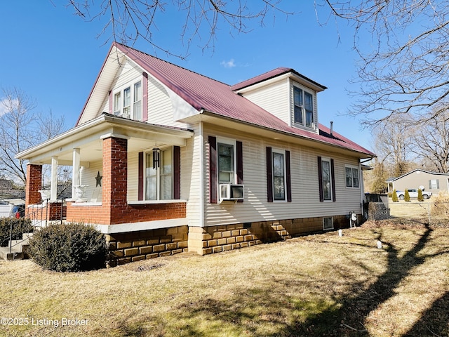 view of property exterior featuring a porch, cooling unit, and a lawn