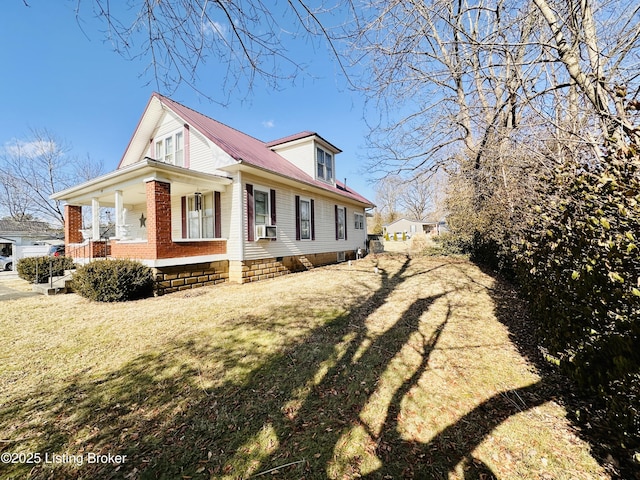 view of home's exterior featuring cooling unit, a lawn, and a porch