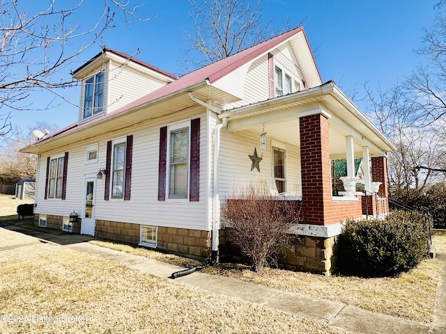 view of side of property featuring a porch