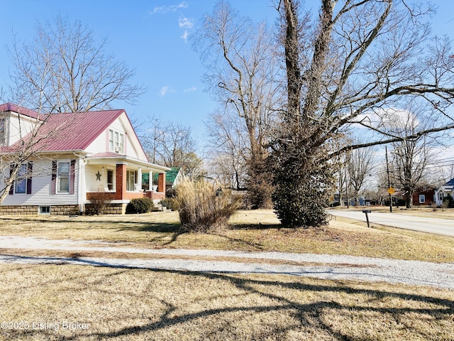 view of side of property featuring covered porch