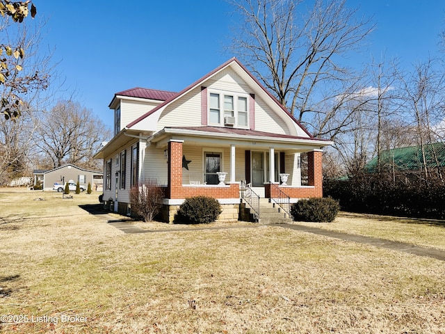 view of front of home featuring a porch, cooling unit, and a front lawn