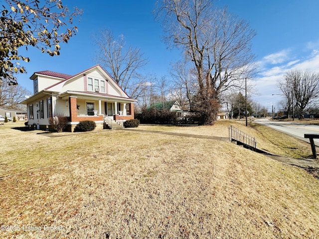 view of home's exterior featuring a yard and a porch