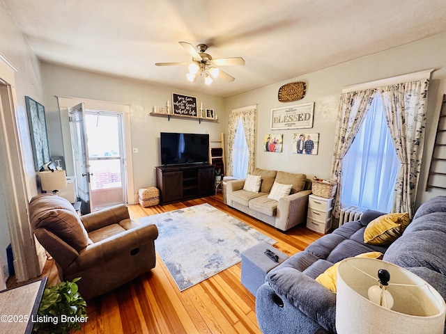 living room with ceiling fan and light hardwood / wood-style floors