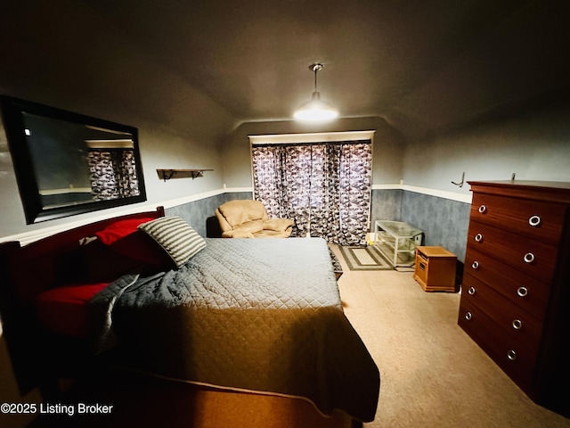 bedroom featuring lofted ceiling and light carpet