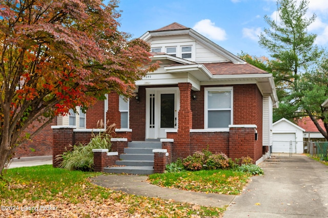 view of front of home with a garage and an outdoor structure