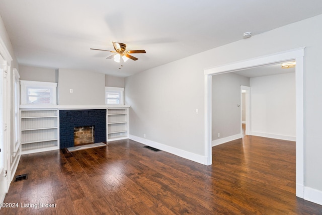 unfurnished living room with dark hardwood / wood-style floors, ceiling fan, and a fireplace