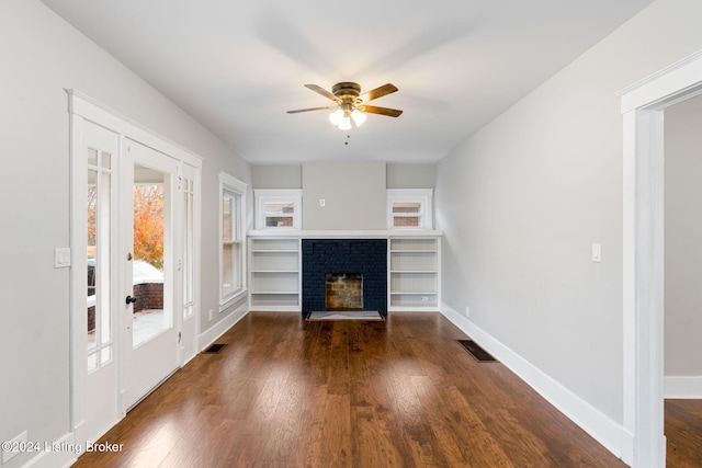 unfurnished living room with ceiling fan, dark hardwood / wood-style floors, and a fireplace