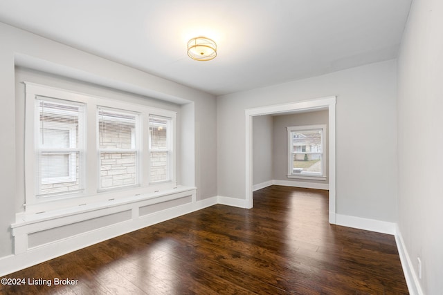 spare room featuring dark hardwood / wood-style floors