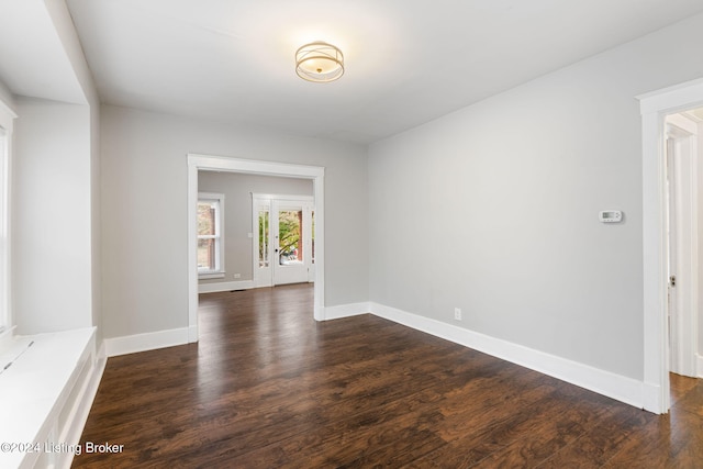 unfurnished room with dark hardwood / wood-style flooring