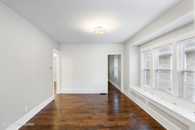 unfurnished room featuring dark hardwood / wood-style flooring