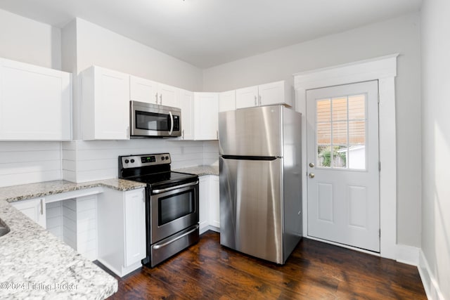 kitchen with white cabinetry, light stone countertops, and stainless steel appliances