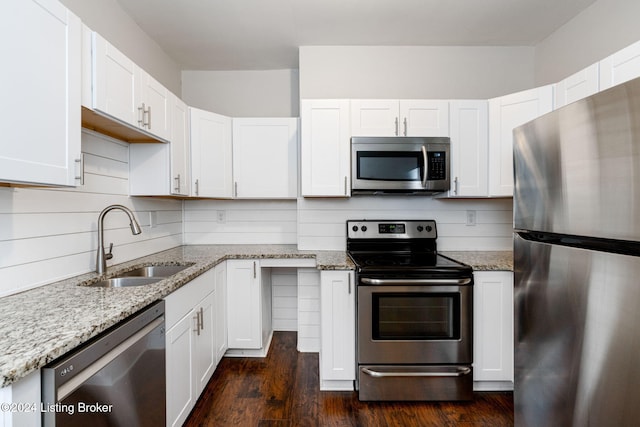 kitchen featuring white cabinetry, sink, decorative backsplash, and appliances with stainless steel finishes