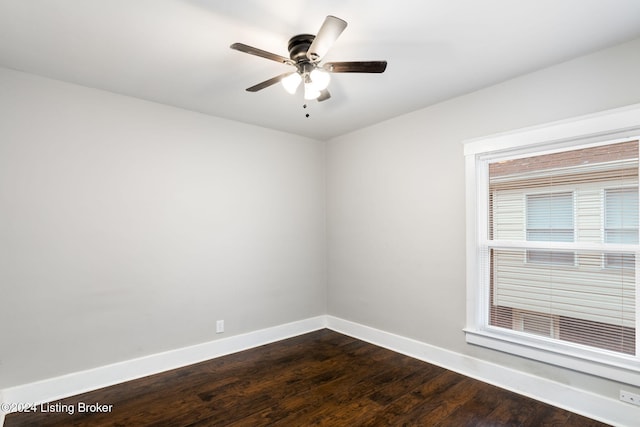 spare room with dark hardwood / wood-style floors and ceiling fan