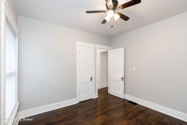 unfurnished bedroom with dark wood-type flooring and ceiling fan