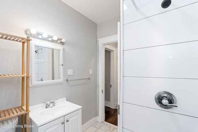 bathroom featuring vanity and a shower