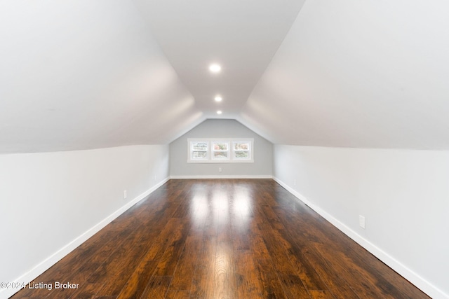 additional living space with lofted ceiling and dark hardwood / wood-style flooring