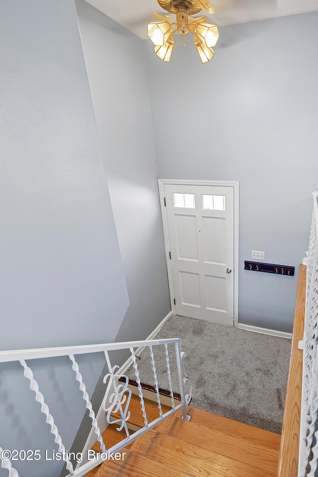 carpeted foyer entrance with ceiling fan