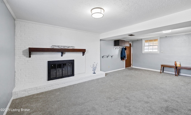 unfurnished living room with ornamental molding, a brick fireplace, carpet, and a textured ceiling