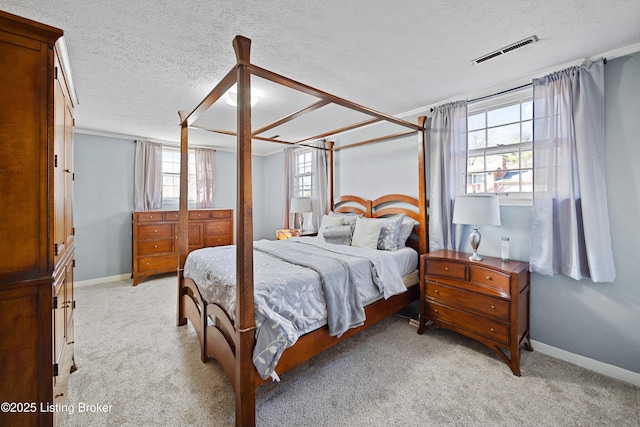 bedroom featuring light carpet and a textured ceiling