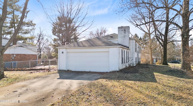 view of property exterior with a yard and a garage