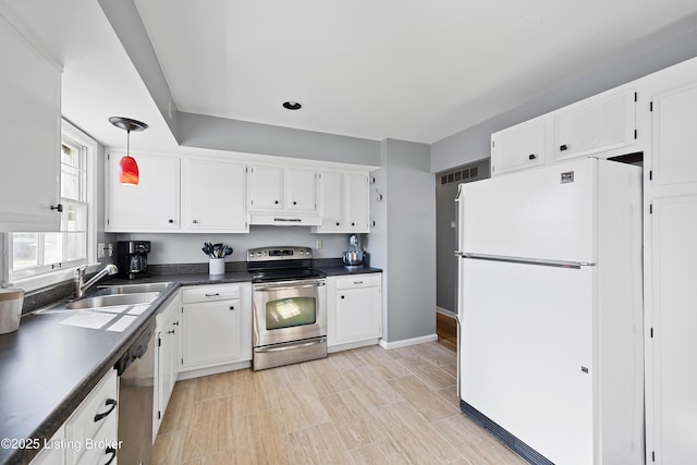 kitchen with white cabinetry, appliances with stainless steel finishes, sink, and hanging light fixtures