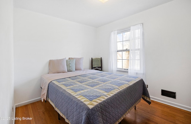 bedroom with dark wood-type flooring