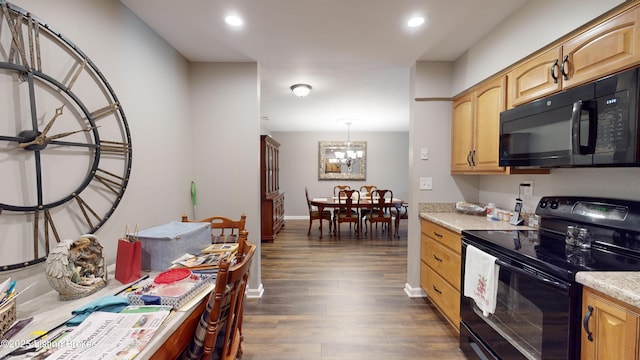 kitchen featuring pendant lighting, a notable chandelier, dark hardwood / wood-style flooring, and black appliances