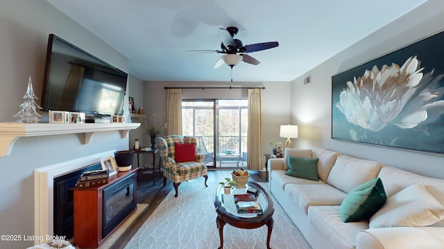 living room featuring hardwood / wood-style flooring and ceiling fan