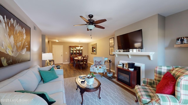 living room with hardwood / wood-style floors and ceiling fan