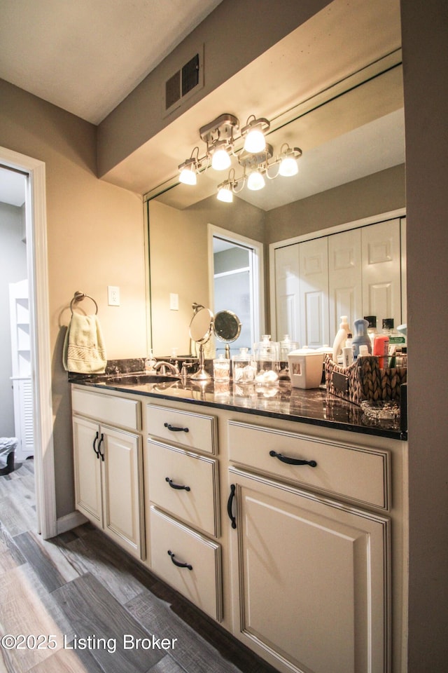 bathroom with vanity and wood-type flooring