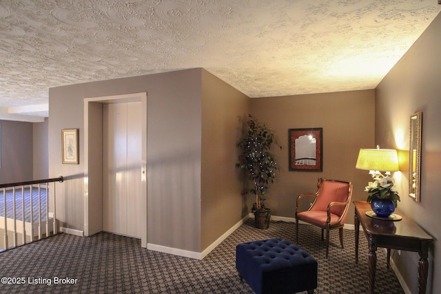 sitting room with carpet flooring and a textured ceiling