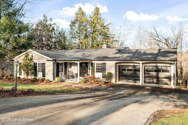 ranch-style house featuring a porch and a garage