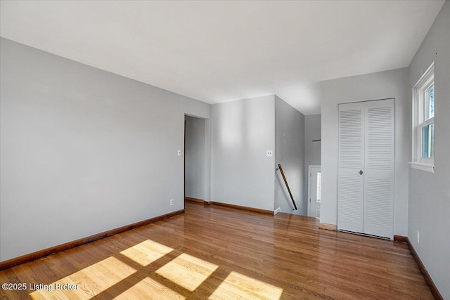 empty room with hardwood / wood-style flooring