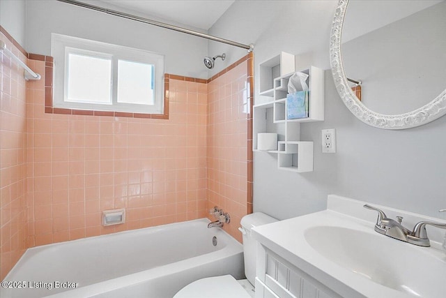 full bathroom with tiled shower / bath, vanity, and toilet