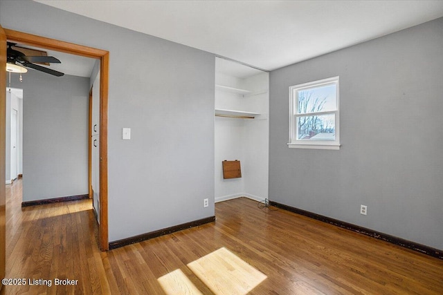 empty room with wood-type flooring and ceiling fan