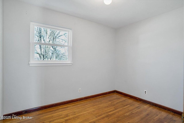 empty room with hardwood / wood-style flooring