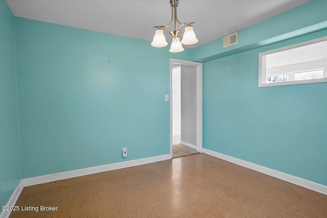 empty room with an inviting chandelier