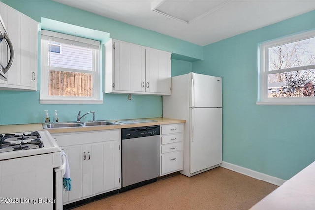 kitchen with white cabinetry, sink, and stainless steel appliances