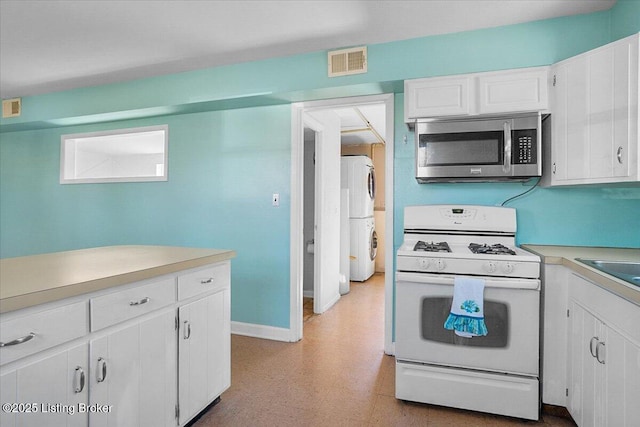 kitchen featuring white cabinetry and white appliances