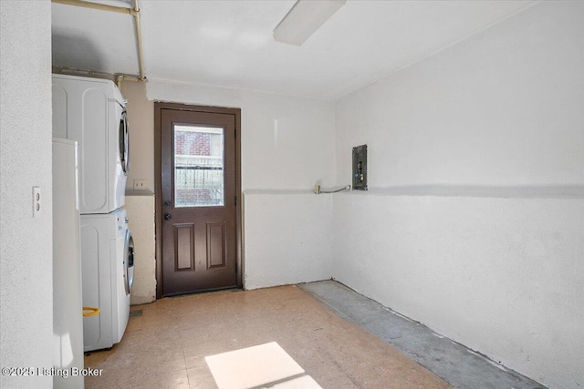 interior space featuring stacked washer and dryer and electric panel