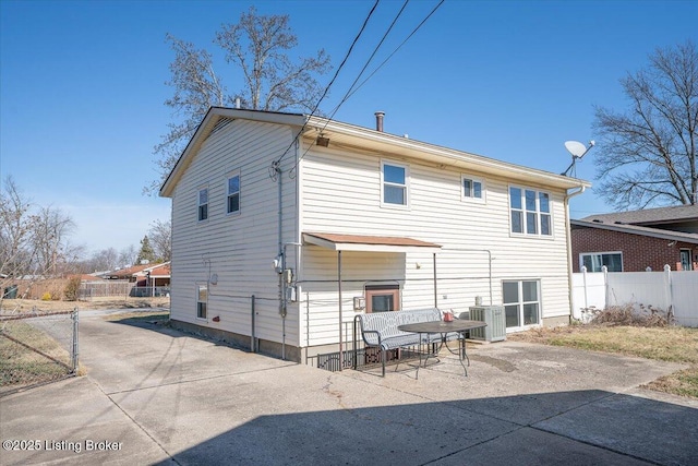 rear view of property featuring central AC and a patio