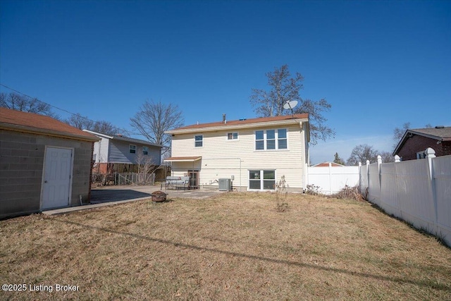 rear view of property featuring cooling unit, a patio, and a lawn