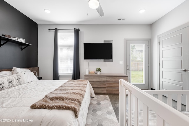 bedroom featuring ceiling fan, multiple windows, and access to outside