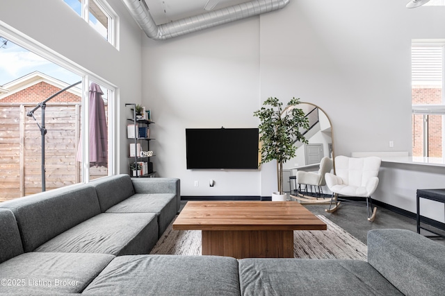 living room with a wealth of natural light and a high ceiling