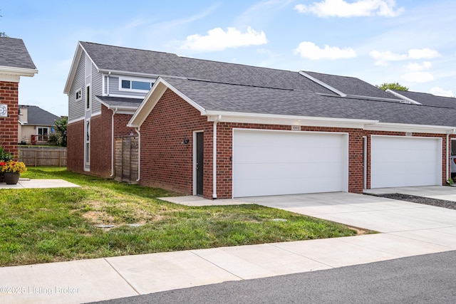 view of front of home featuring a garage and a front lawn