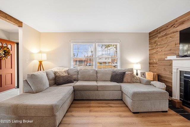 living room featuring wooden walls and light wood-type flooring