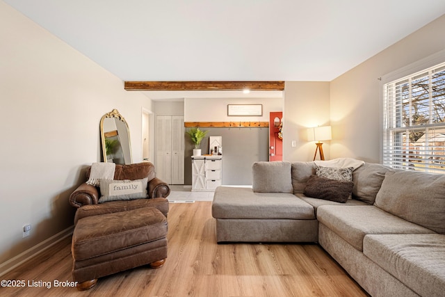 living room with beam ceiling and light wood-type flooring