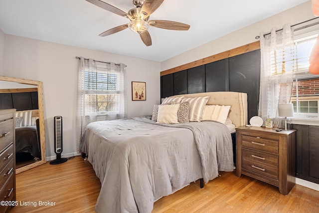 bedroom with light hardwood / wood-style flooring and ceiling fan