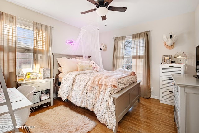 bedroom with ceiling fan and light hardwood / wood-style floors