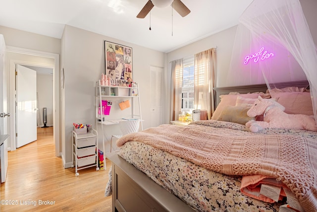 bedroom with a closet, ceiling fan, and light hardwood / wood-style flooring